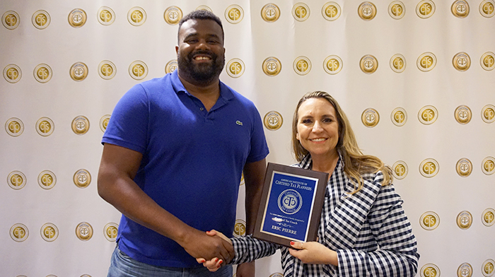 Eric Pierre accepting tax coach certifiication